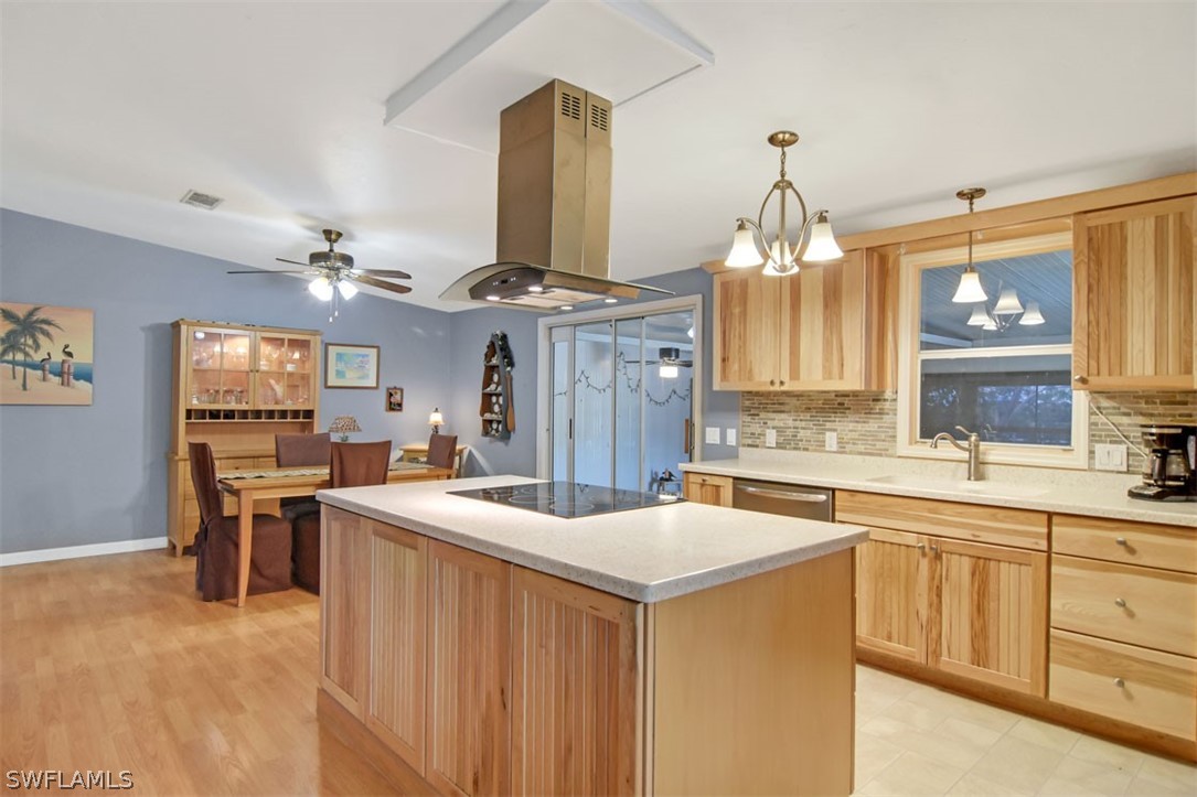 7695 Farrell Road Bokeelia, FL 33922 - Photo 2 of 28 a kitchen with a sink stove and cabinets