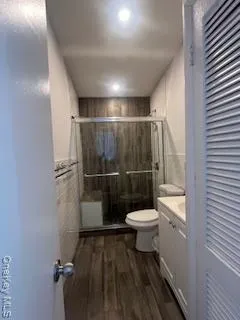 a bathroom with a toilet and a shower