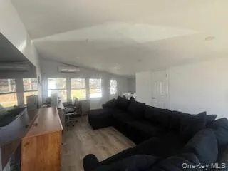 a living room with furniture window and wooden floor