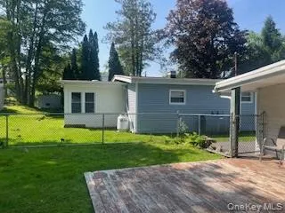 a view of a house with backyard and porch