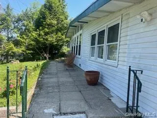 a view of a patio with table and chairs and potted plants
