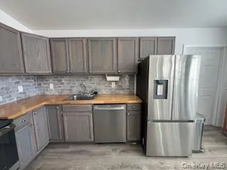 a kitchen with stainless steel appliances granite countertop a refrigerator a stove a sink and a granite counter tops