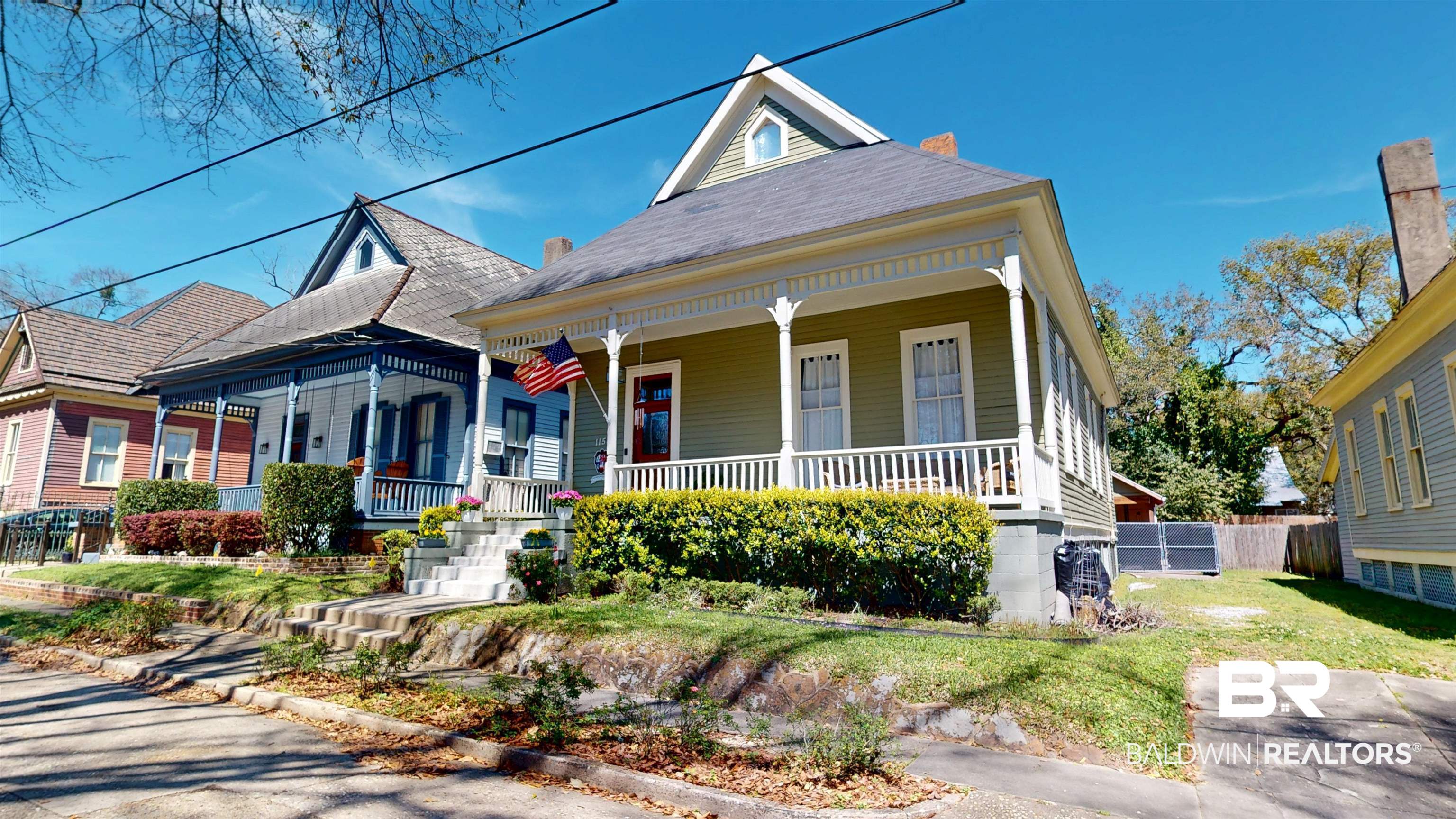 1154 New St Francis Street Mobile, AL 36604 - Photo 4 of 37 View of front facade with a porch, fence, a front lawn, and a chimney