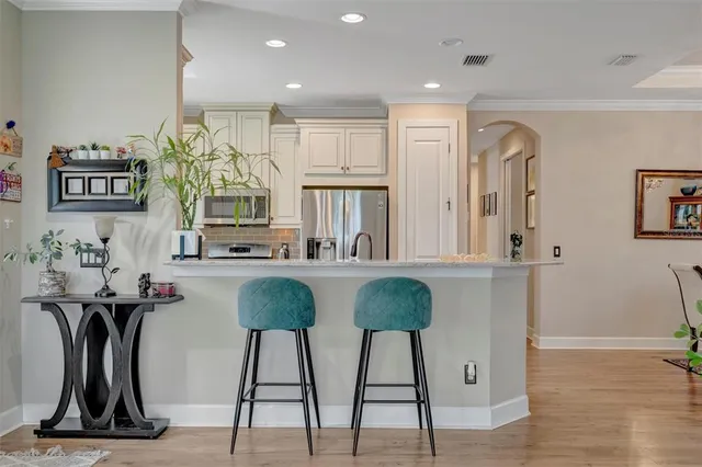 a kitchen with a refrigerator and a sink
