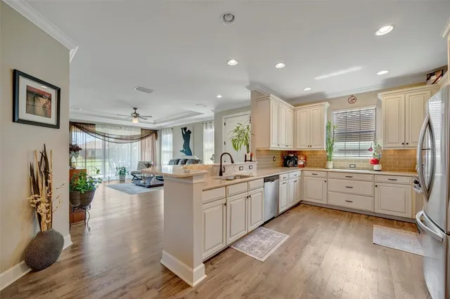 a view of a dining room with furniture and chandelier