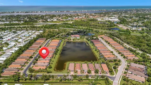 an aerial view of residential houses with outdoor space and swimming pool