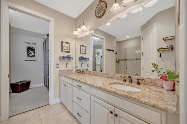 an aerial view of a house with a swimming pool and lake view