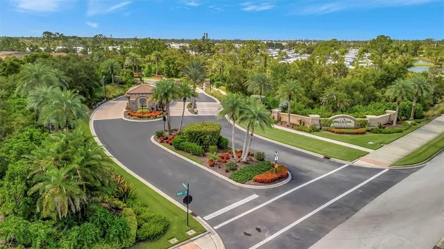 an aerial view of a house with a garden and lake view
