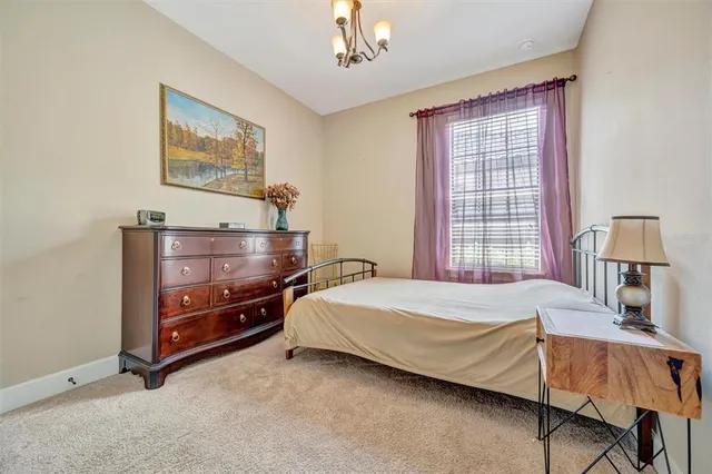 a kitchen with stainless steel appliances granite countertop a dining table chairs and chandelier