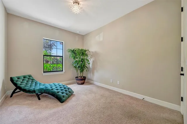 a living room with furniture a flat screen tv and a large window