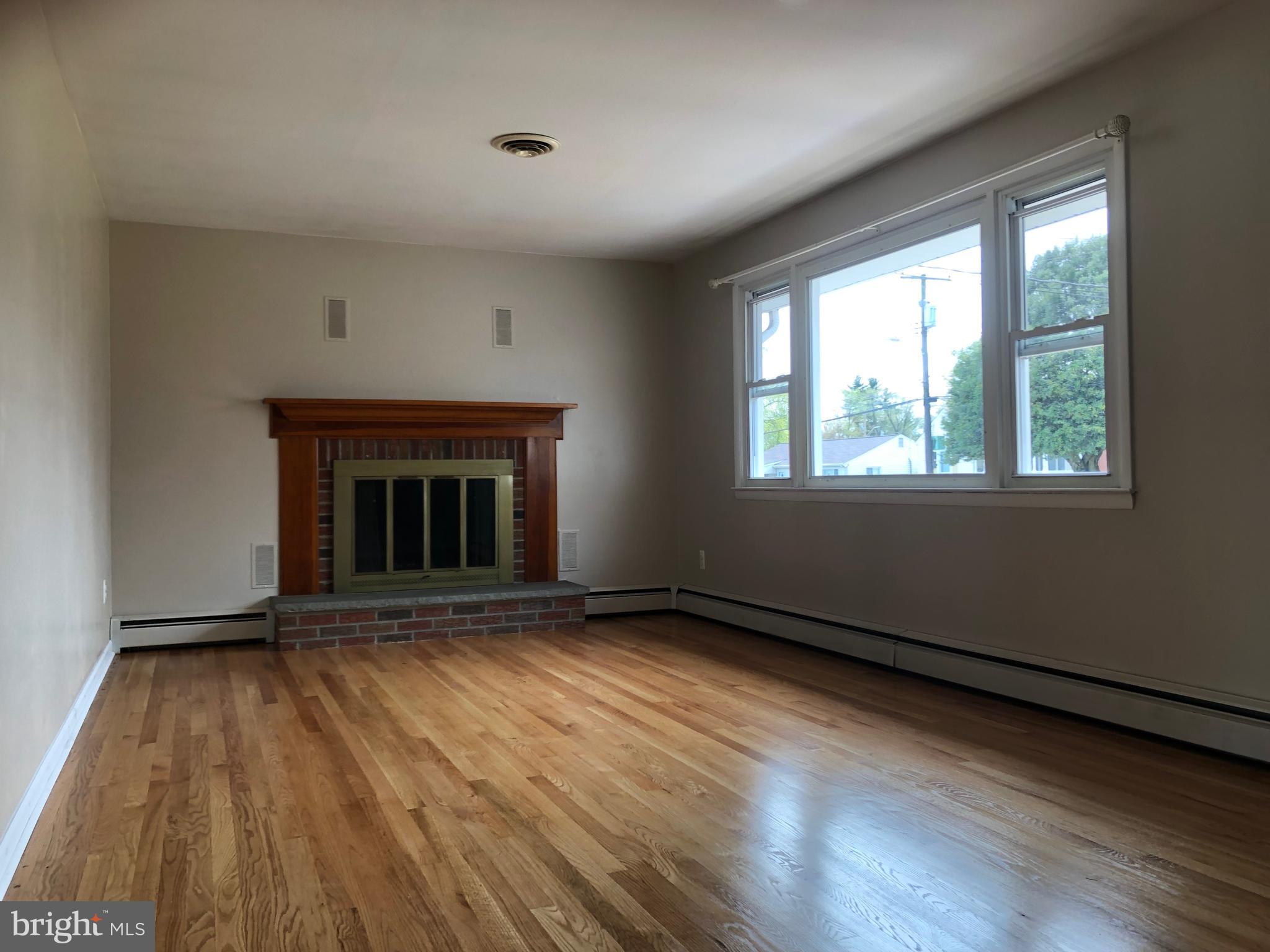 8459 Geneva Road Pasadena, MD 21122 - Photo 4 of 16 spacious living room with beautiful hardwood floor