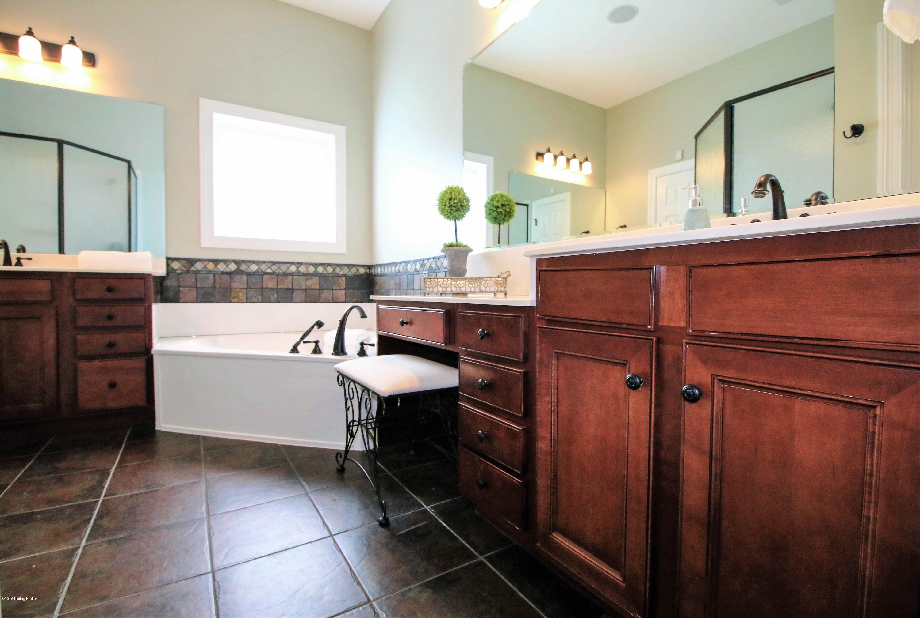 2904 Doe Ridge Court Prospect, KY 40059 - Photo 17 of 86 The luxurious master bath features separate vanities with sleek black hardware and gleaming white tops. The abundant cabinetry offers a design which emphasizes storage and beauty!