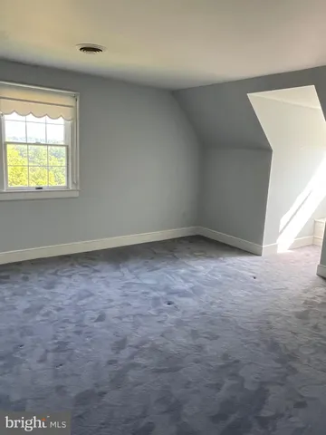 a white toilet sitting next to a bathroom sink and a mirror