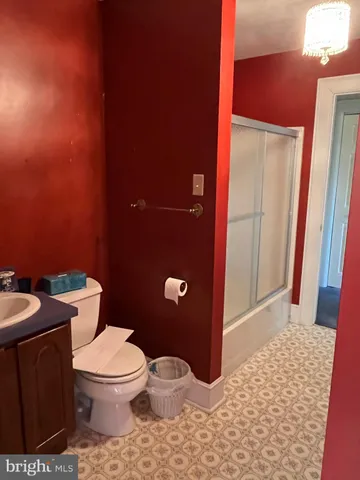 a view of a room with wooden floor and chandelier
