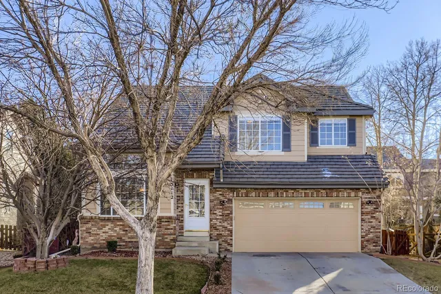 a large brick building with a large tree