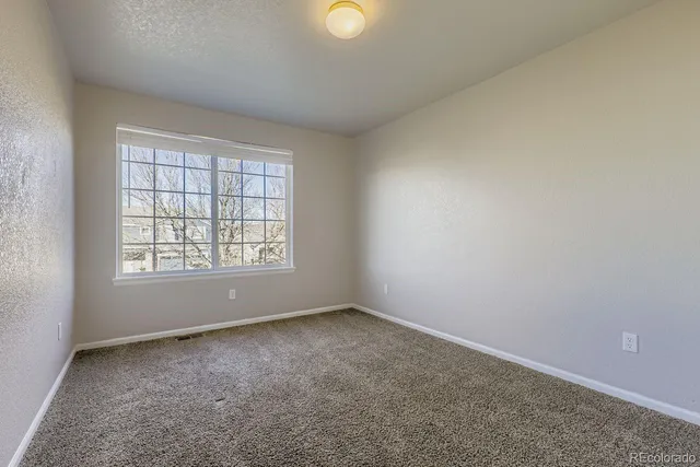 an empty room with windows and with windows