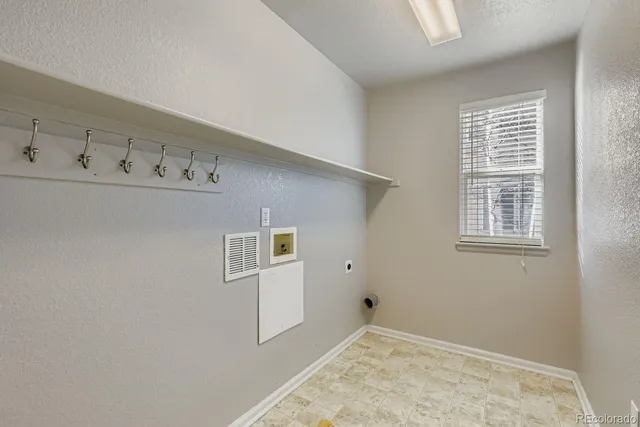 a view of an empty room with closet and wooden floor