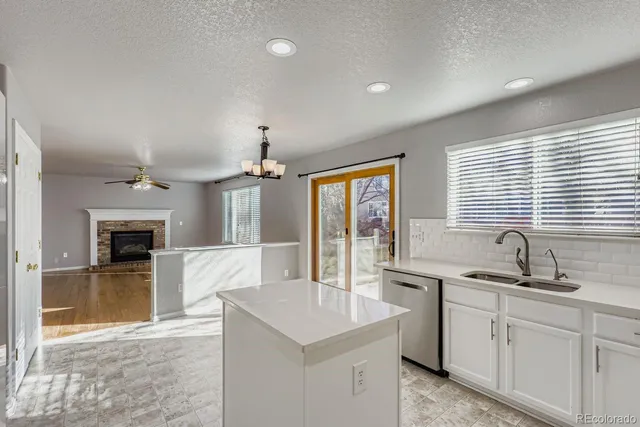 a kitchen with sink stove and refrigerator