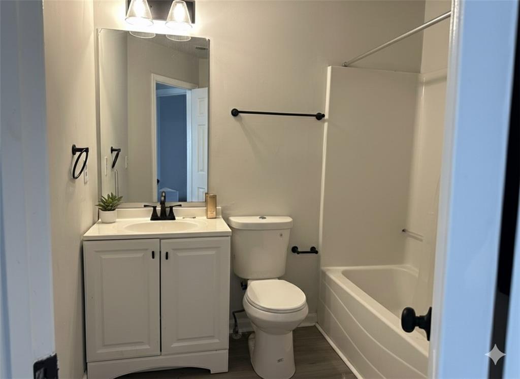 8258 Champion Trail Fairburn, GA 30213 - Photo 7 of 7 a bathroom with a sink a toilet and shower