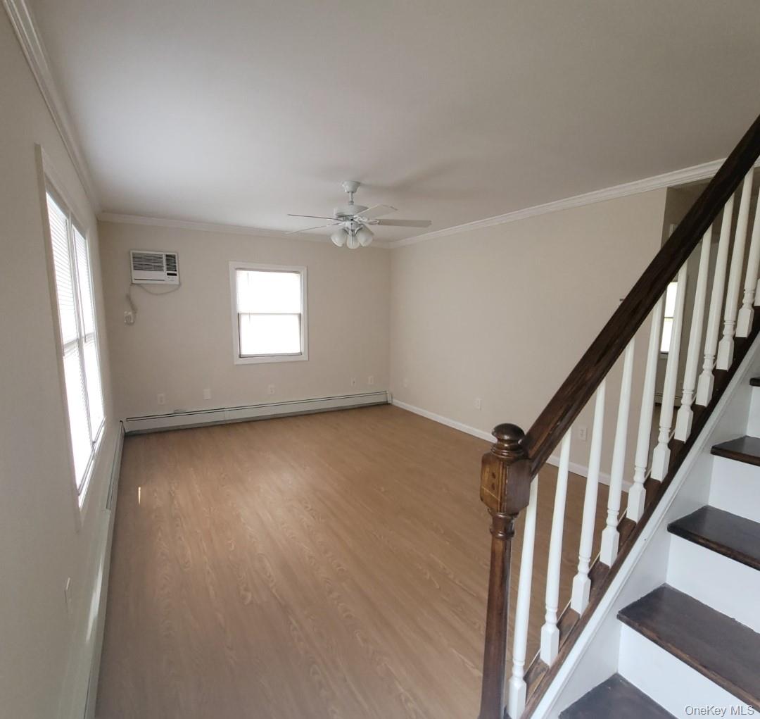 49 Azalea Road Levittown, NY 11756 - Photo 2 of 17 wooden floor in an empty room with a window