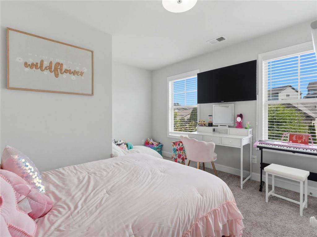 147 Fieldbrook Crossing Canton, GA 30115 - Photo 25 of 46 a bedroom with a bed and a flat screen tv