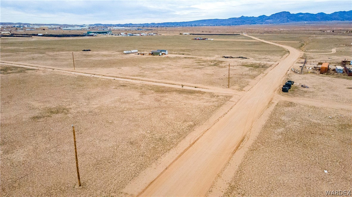 0 East Parker Road, Unit 119 Kingman, AZ 86401 - Photo 7 of 16 Expansive open land featuring a dirt road and distant mountain range
