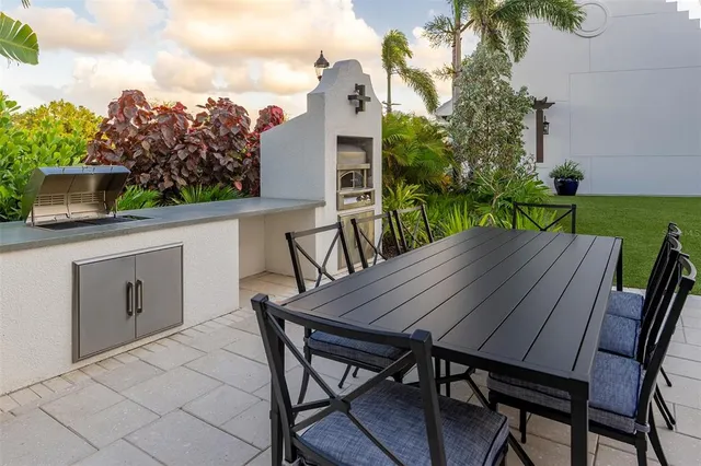 a view of a patio with table and chairs with wooden floor and fence