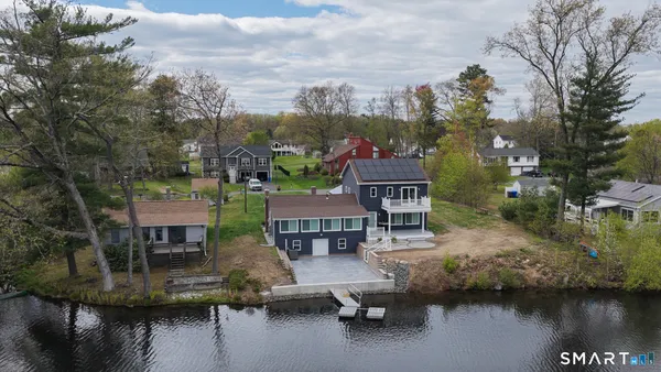 a view of a lake with a house in the background