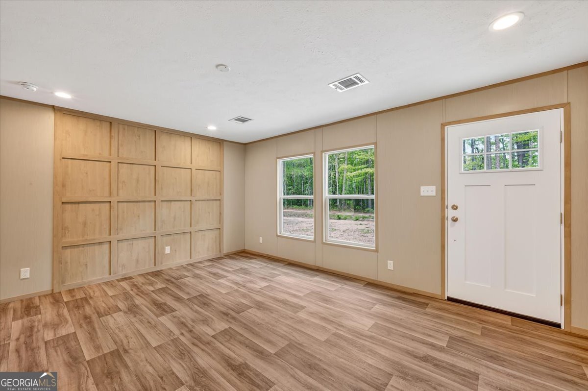 29 Clyde Road White Oak, GA 31568 - Photo 11 of 46 a view of an empty room with wooden floor and a window