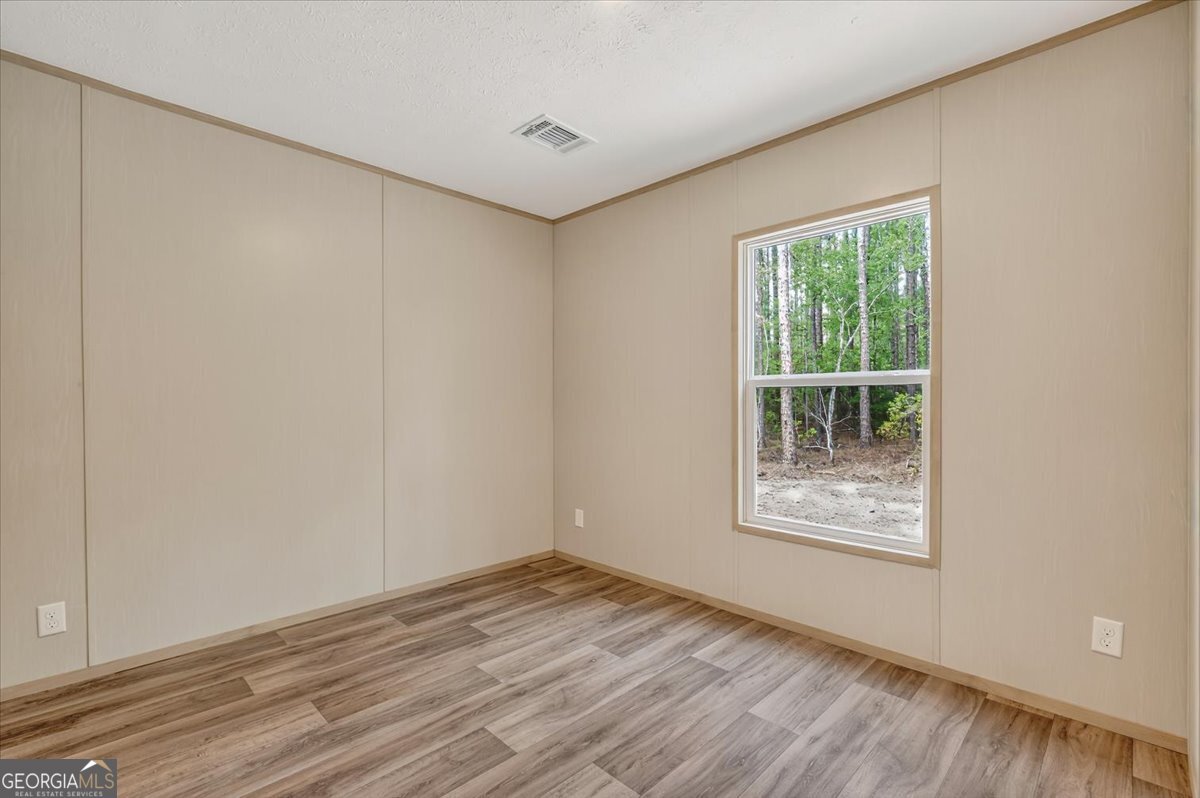 29 Clyde Road White Oak, GA 31568 - Photo 22 of 46 an empty room with wooden floor and windows