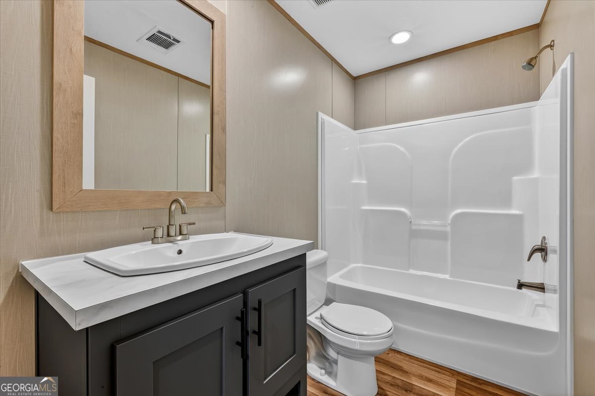 29 Clyde Road White Oak, GA 31568 - Photo 24 of 46 a bathroom with a sink toilet a mirror and shower
