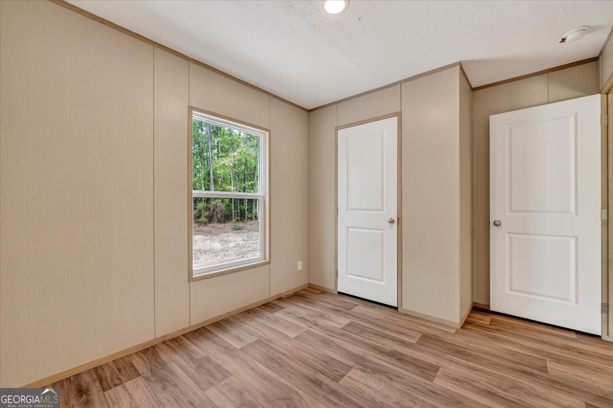 29 Clyde Road White Oak, GA 31568 - Photo 26 of 46 a view of an empty room with wooden floor and a window