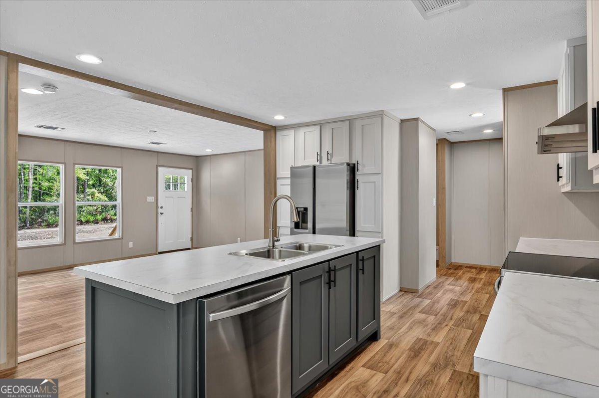 29 Clyde Road White Oak, GA 31568 - Photo 30 of 46 a kitchen with kitchen island a sink appliances and a counter top space