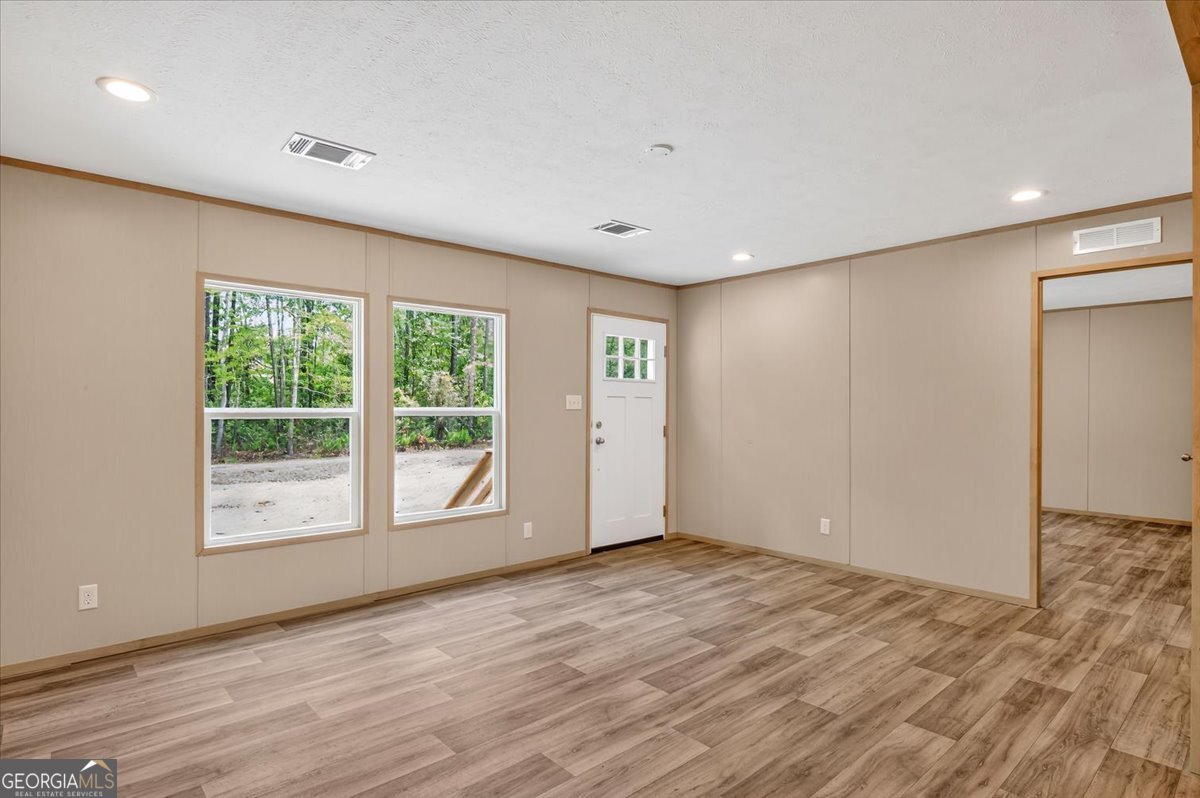 29 Clyde Road White Oak, GA 31568 - Photo 32 of 46 a view of an empty room with wooden floor and a window