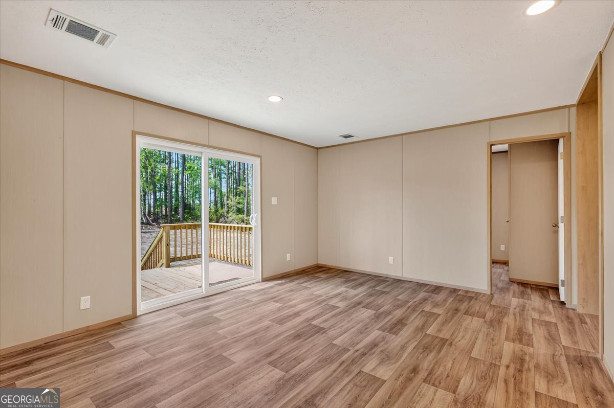 29 Clyde Road White Oak, GA 31568 - Photo 33 of 46 a view of an empty room with wooden floor and a window