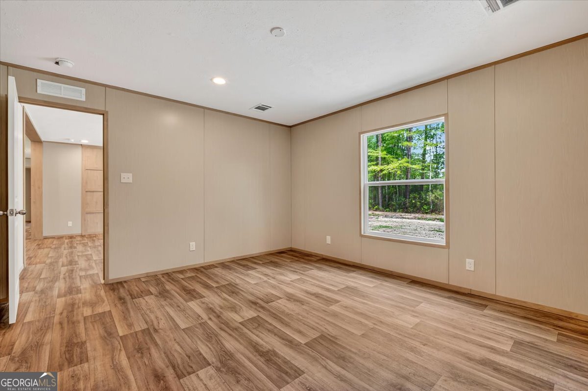 29 Clyde Road White Oak, GA 31568 - Photo 40 of 46 a view of an empty room with wooden floor and a window