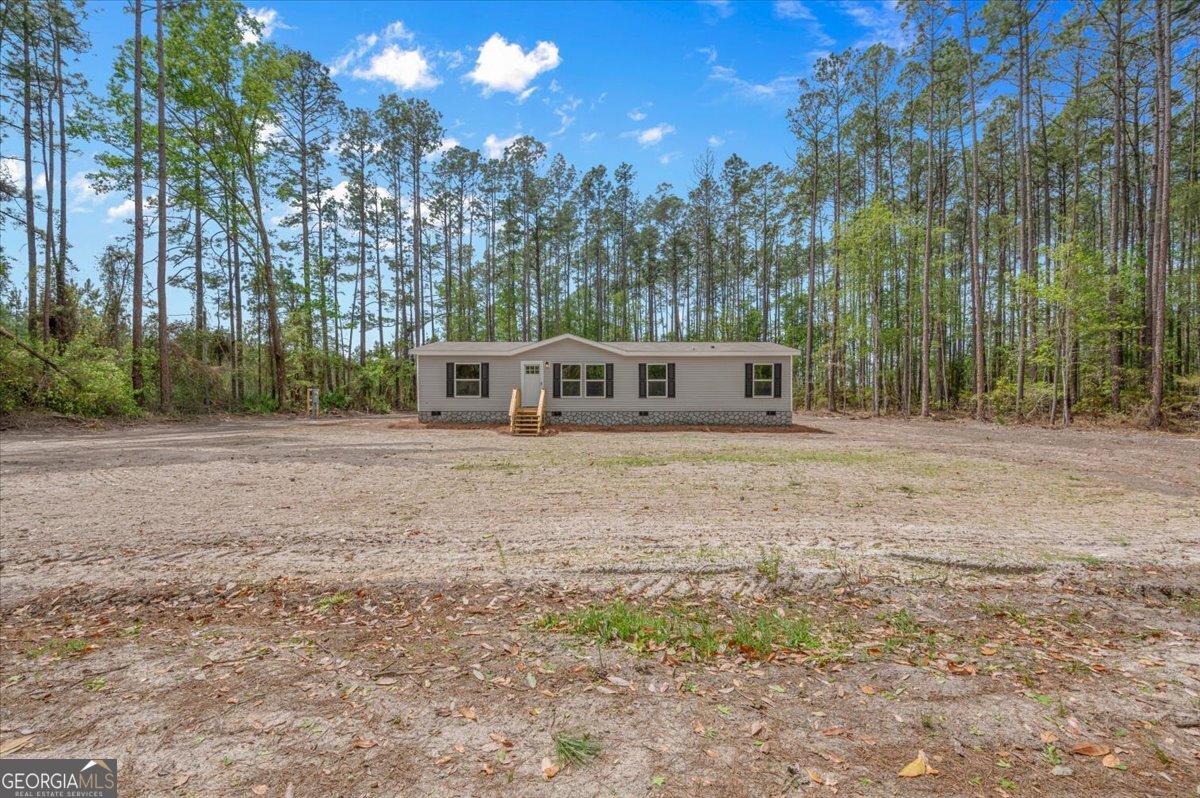 29 Clyde Road White Oak, GA 31568 - Photo 4 of 46 a house with trees in front of it