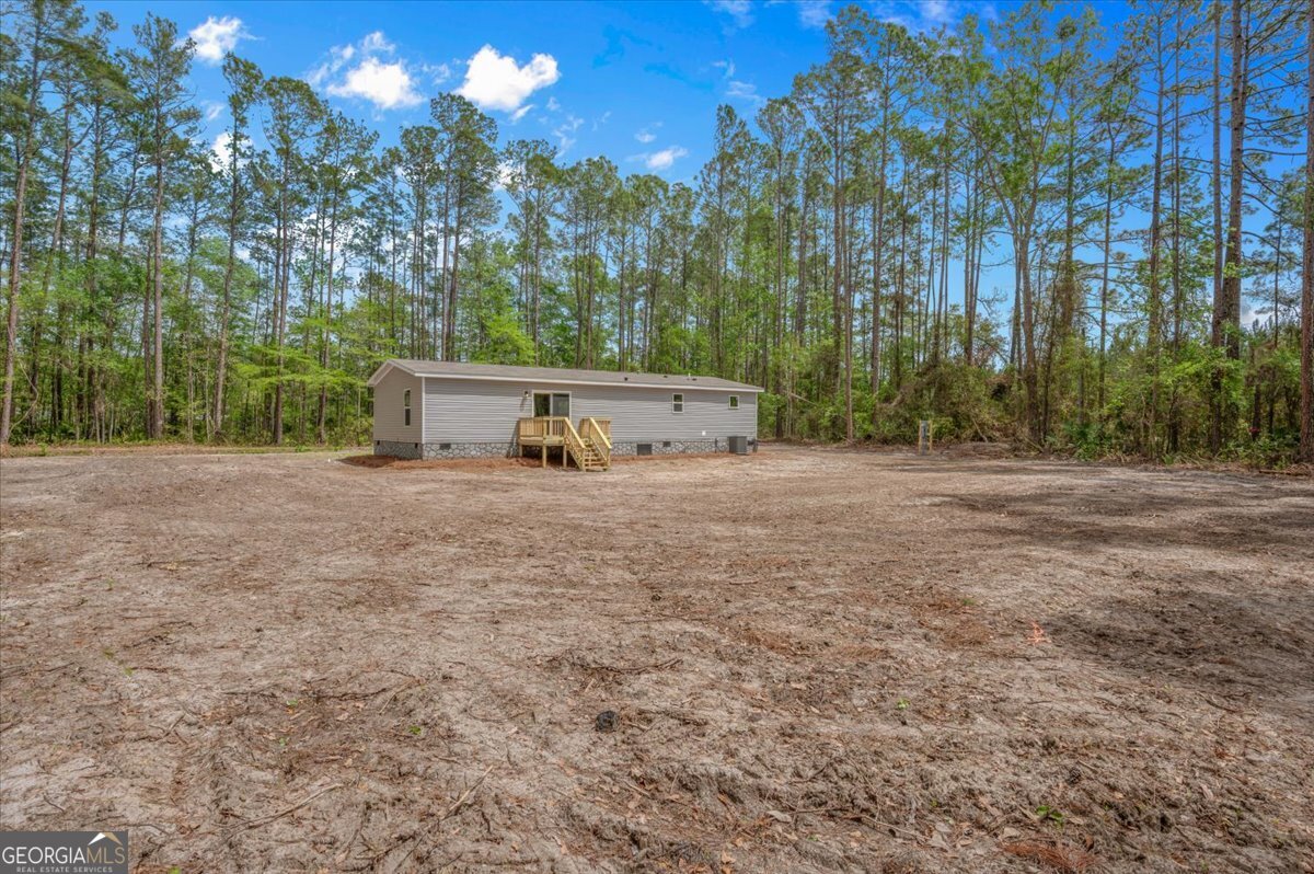 29 Clyde Road White Oak, GA 31568 - Photo 43 of 46 a view of a field with trees in the background
