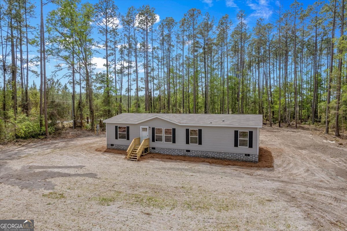 29 Clyde Road White Oak, GA 31568 - Photo 5 of 46 front view of a house with a yard and trees