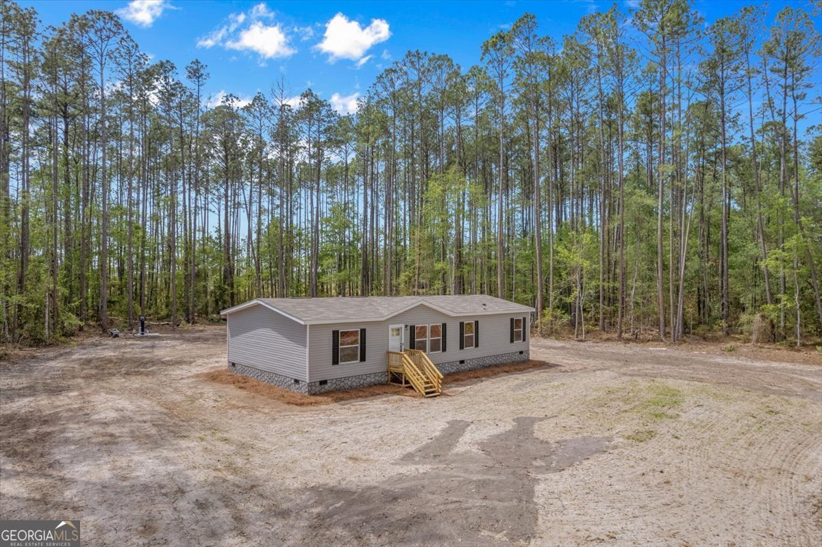 29 Clyde Road White Oak, GA 31568 - Photo 6 of 46 a view of a house with backyard and trees