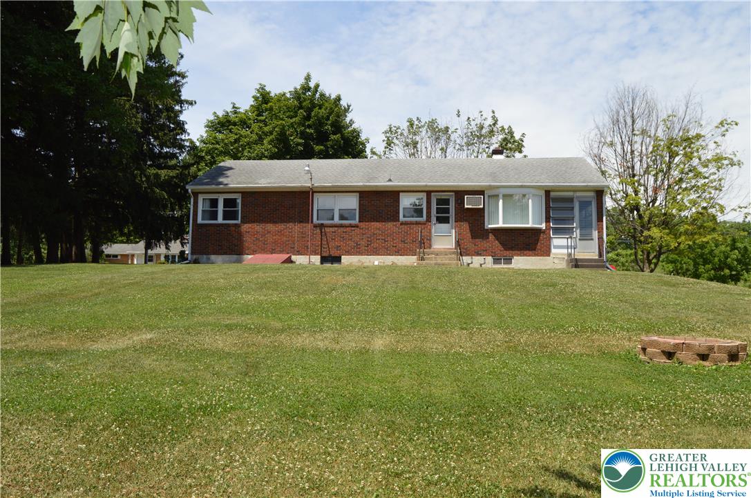 1819 Blue Barn Road Orefield, PA 18069 - Photo 7 of 21 Brick ranch home situated on a generous, verdant lawn, offering ample outdoor space and potential.