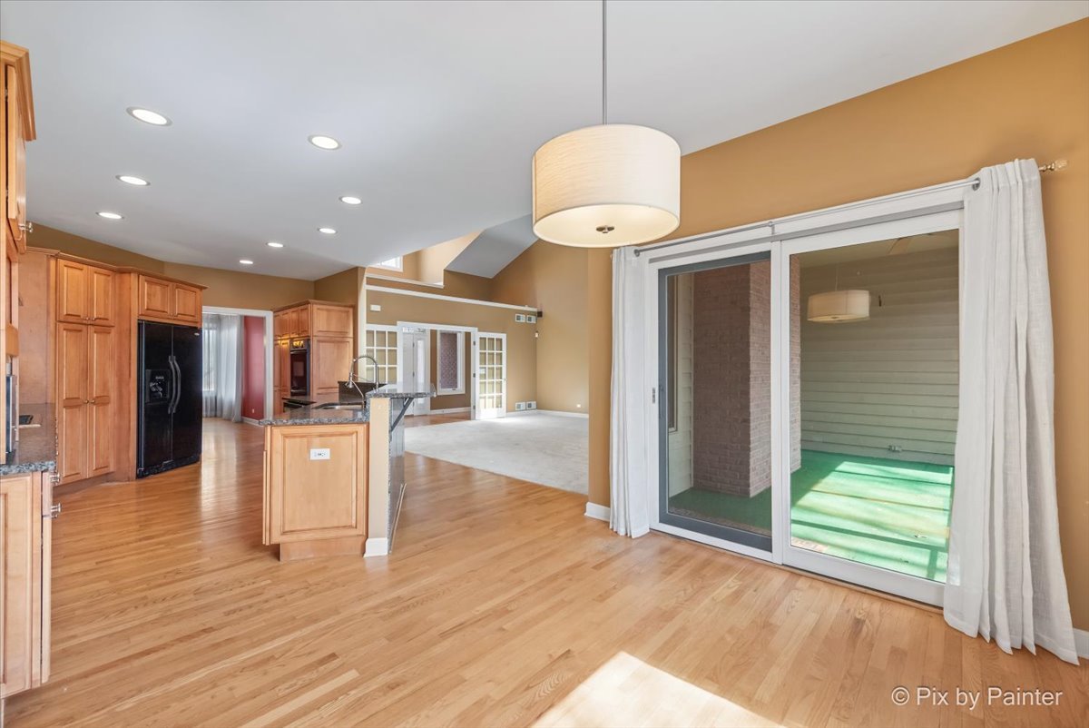 28935 Fox Street Cary, IL 60013 - Photo 12 of 50 a view of a kitchen with a sink and chandelier or wooden floor