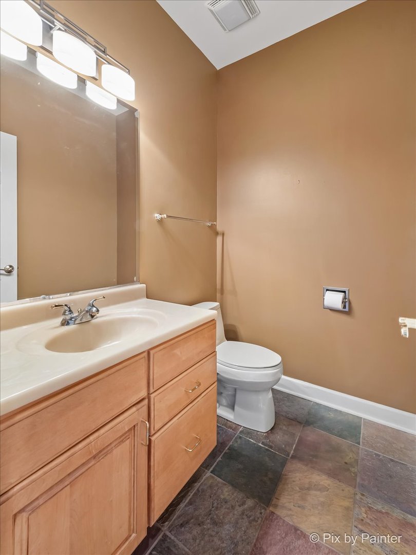 28935 Fox Street Cary, IL 60013 - Photo 24 of 50 a bathroom with a toilet a sink and mirror