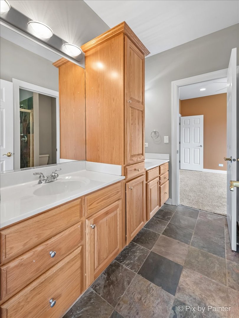 28935 Fox Street Cary, IL 60013 - Photo 31 of 50 a spacious bathroom with a mirror sink and vanity