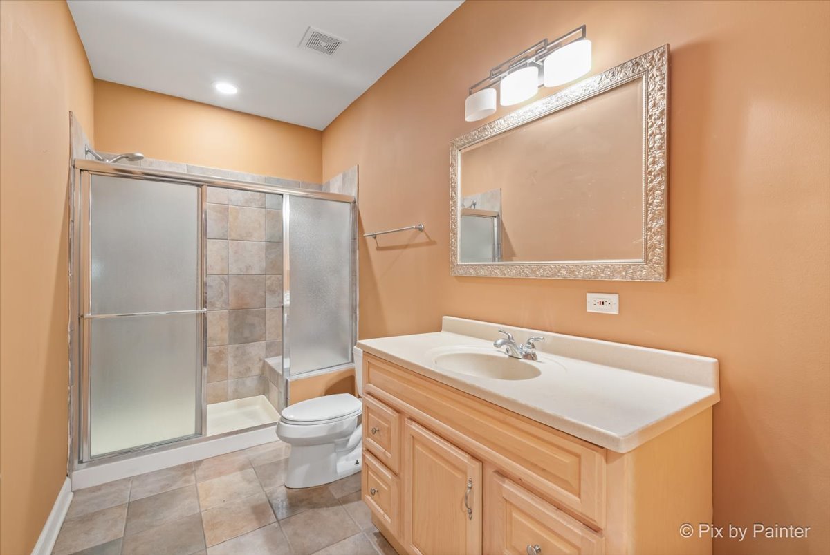 28935 Fox Street Cary, IL 60013 - Photo 39 of 50 a bathroom with a sink a toilet and shower