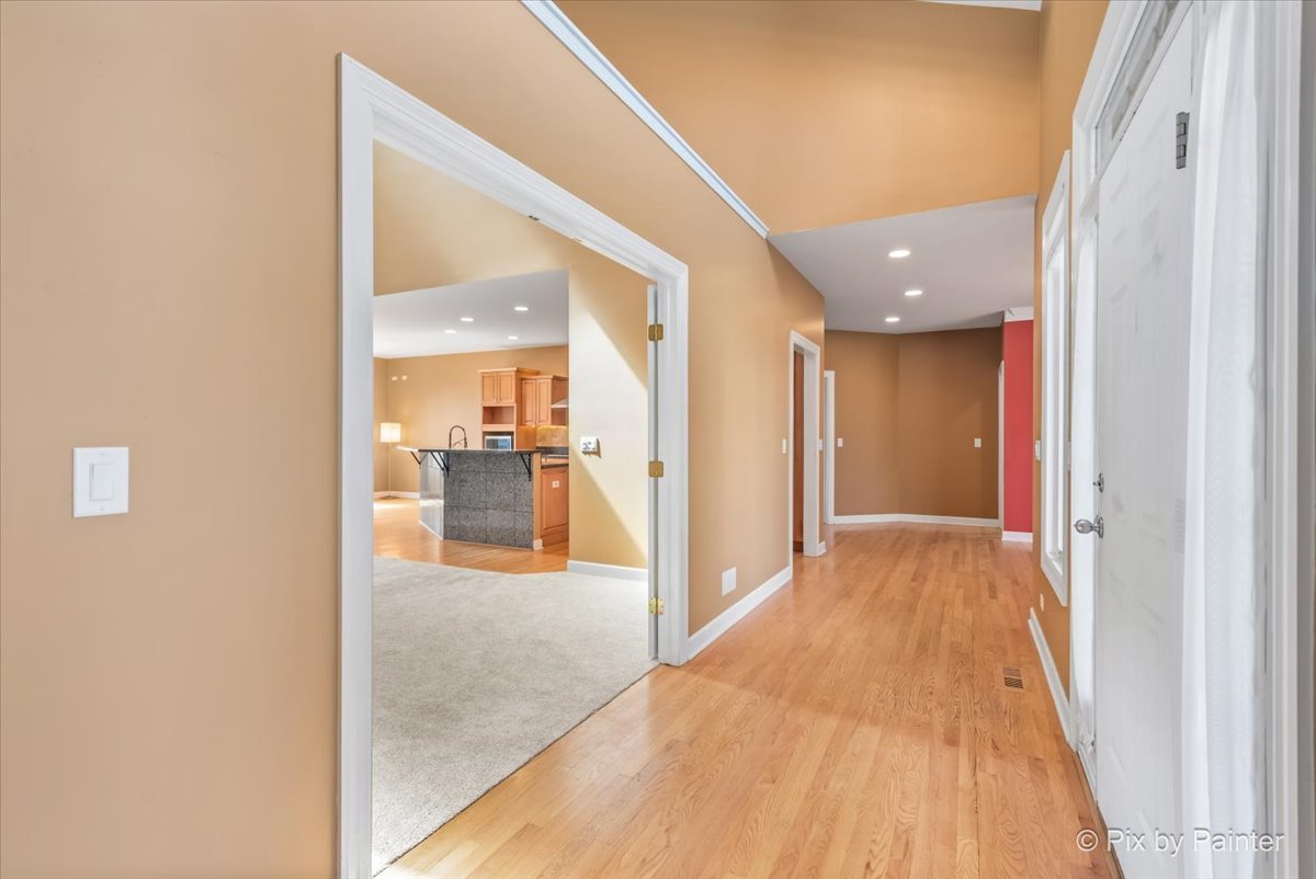 28935 Fox Street Cary, IL 60013 - Photo 4 of 50 a view of a hallway with wooden floor and a bathroom