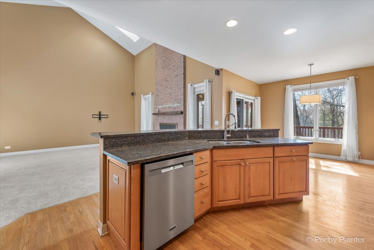 28935 Fox Street Cary, IL 60013 - Photo 9 of 50 a kitchen with stainless steel appliances granite countertop a stove and a sink