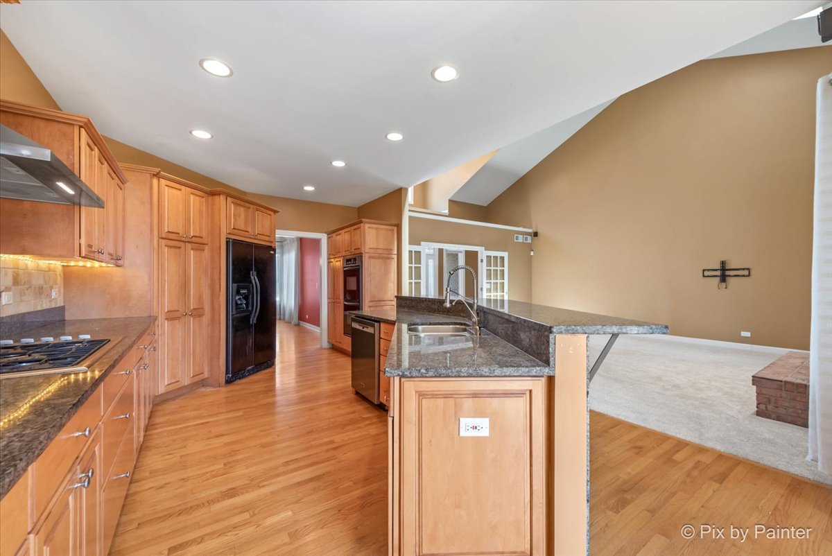 28935 Fox Street Cary, IL 60013 - Photo 10 of 50 a kitchen with stainless steel appliances granite countertop a sink and cabinets