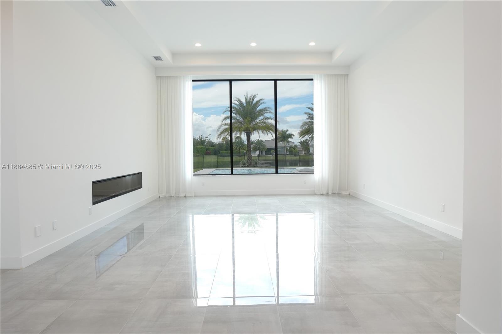 17241 Carretto Court Boca Raton, FL 33496 - Photo 21 of 35 an empty room with large windows