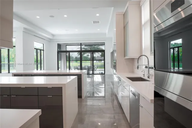 a kitchen with stainless steel appliances granite countertop a stove a refrigerator and a sink